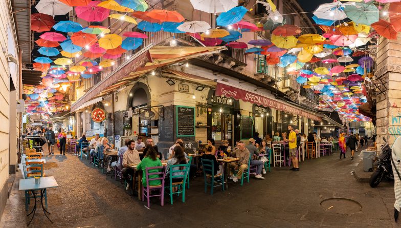 Old town with colorful umbrellas over the street in Catania, Sicily island, Italy